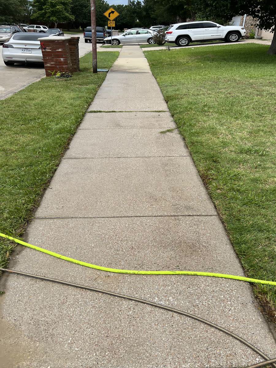 Clean concrete sidewalk after pressure washing
