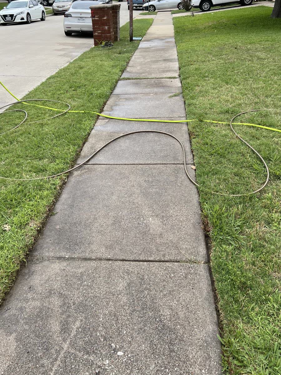 Dirty stained concrete sidewalk before pressure washing