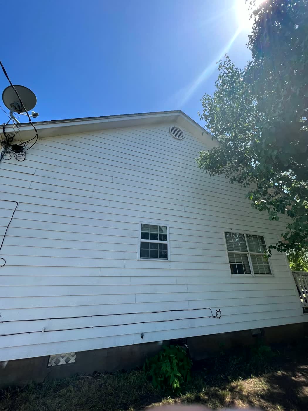 Clean bright white house siding after pressure washing